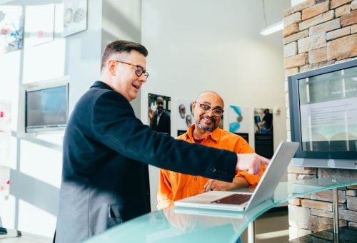 two men working at the front counter of a business