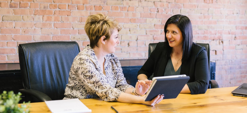 two colleagues sitting at a desk working together