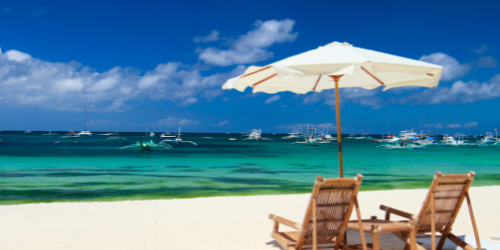 two beach chairs on a white sandy beach